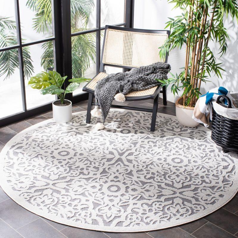 Ivory and Grey Round Geometric Synthetic Indoor/Outdoor Rug