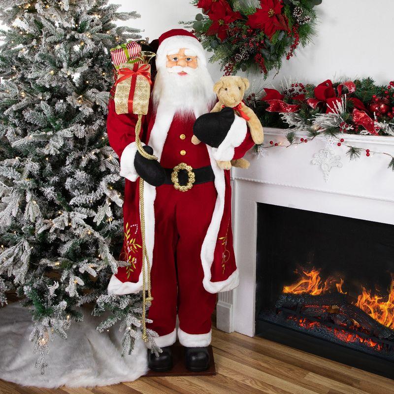 Life-Size Red and White Santa Claus Figurine with Teddy Bear