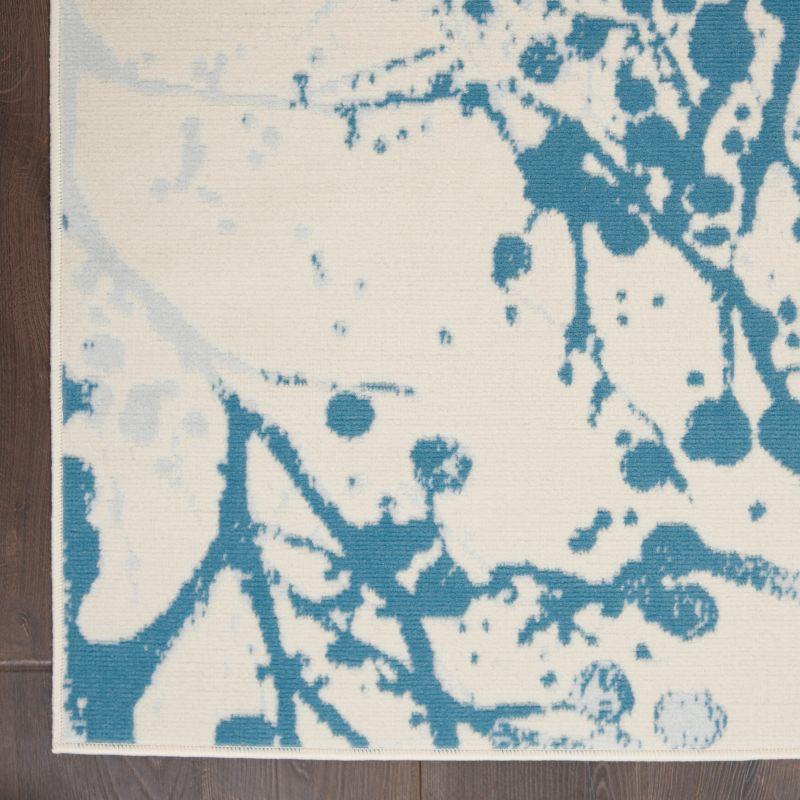 Ivory and Blue Abstract Synthetic 4' x 6' Easy-Care Area Rug