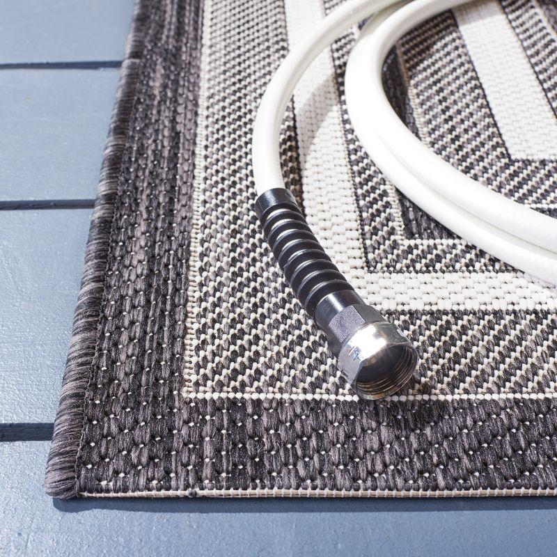 Ivory and Black Reversible Synthetic Indoor/Outdoor Rug