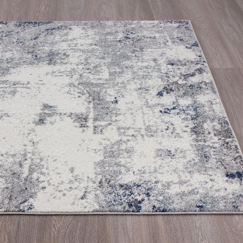 Abstract Ivory Synthetic 5' x 7' Easy-Care Area Rug