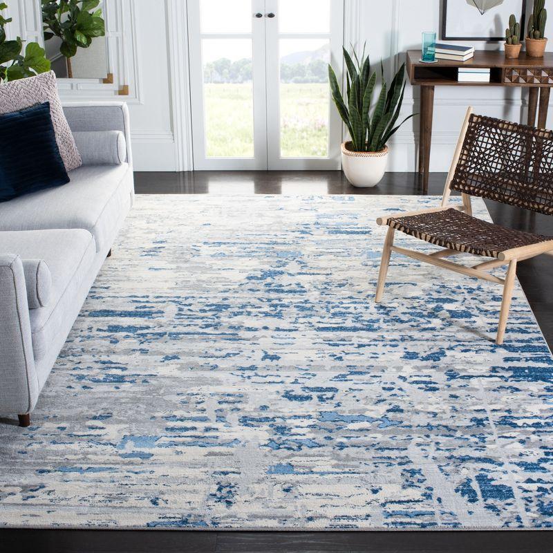 Ivory/Blue Abstract Synthetic 8' x 10' Easy Care Area Rug