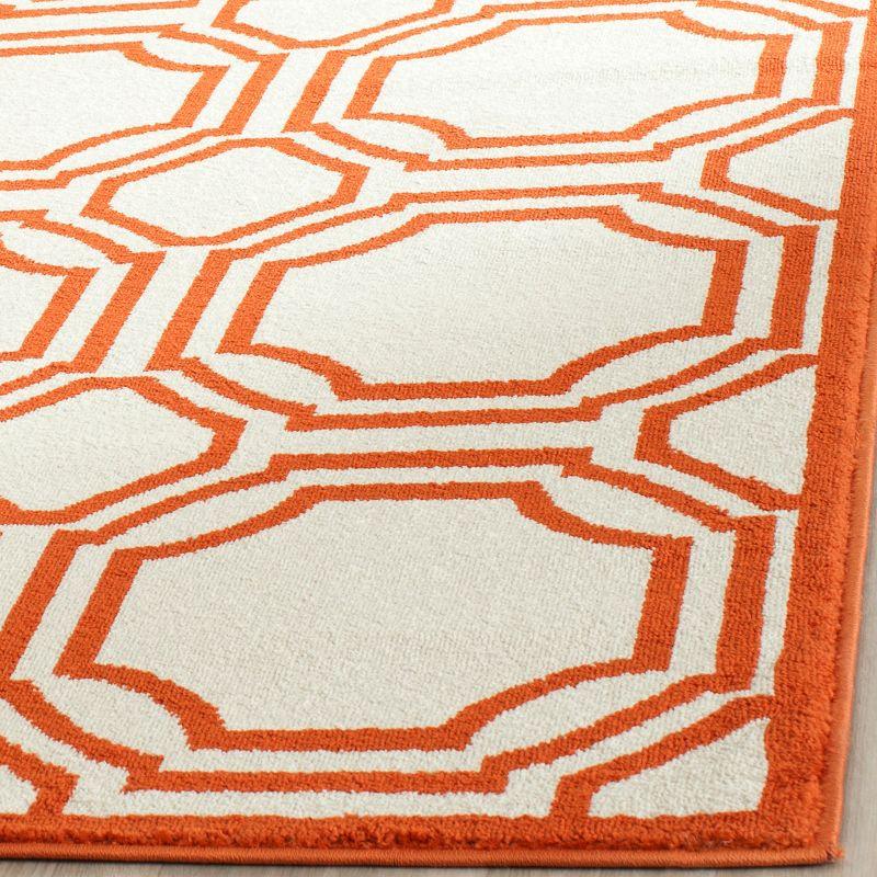 Ivory and Orange Geometric 8' x 10' Stain-Resistant Synthetic Rug