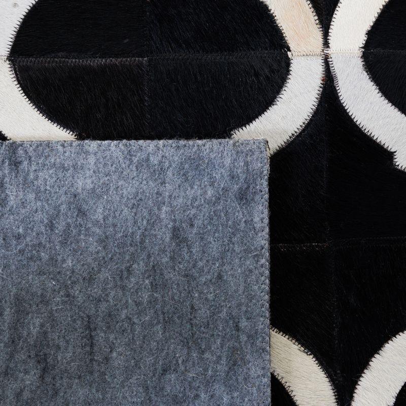 Handmade Black and Beige Geometric Cowhide Area Rug