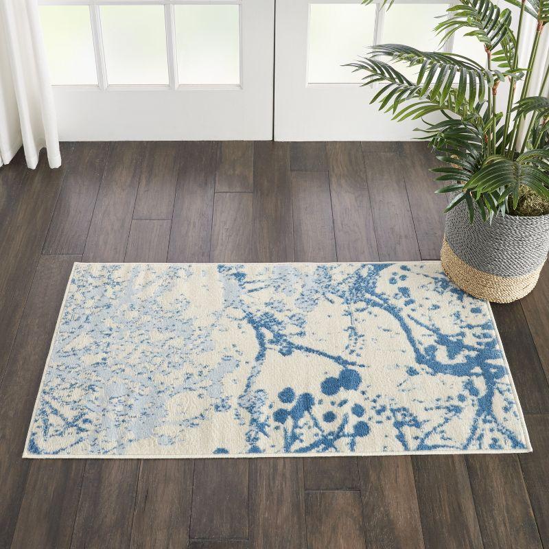 Ivory and Blue Abstract Synthetic 2' x 4' Easy-Care Area Rug