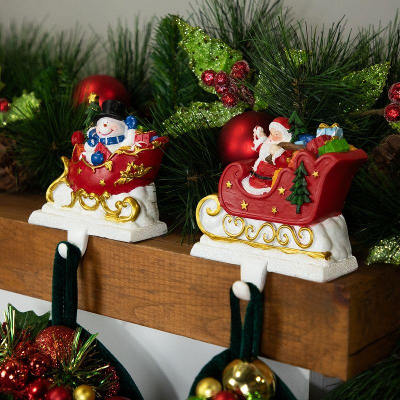 Santa and Snowman Sleigh Ride Resin Stocking Holders Set