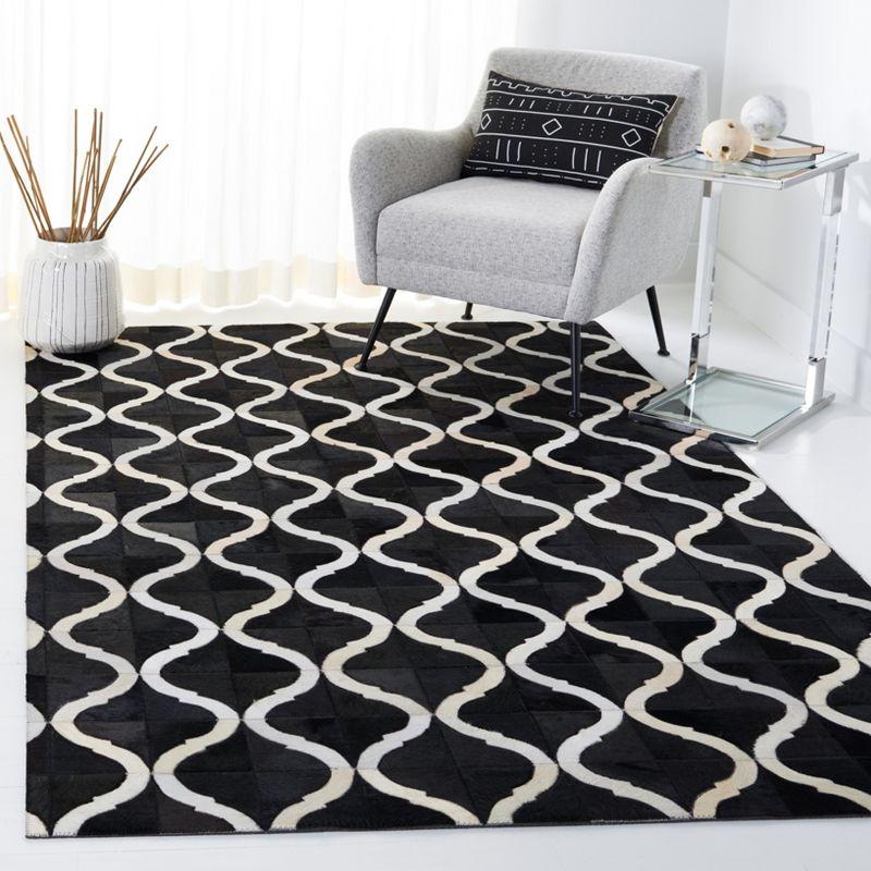 Handmade Black and Beige Geometric Cowhide Area Rug