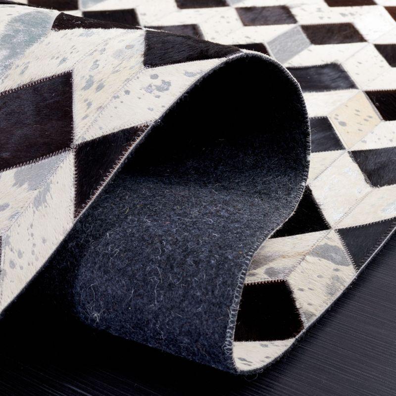 Handmade Black and Beige Geometric Cowhide Rug