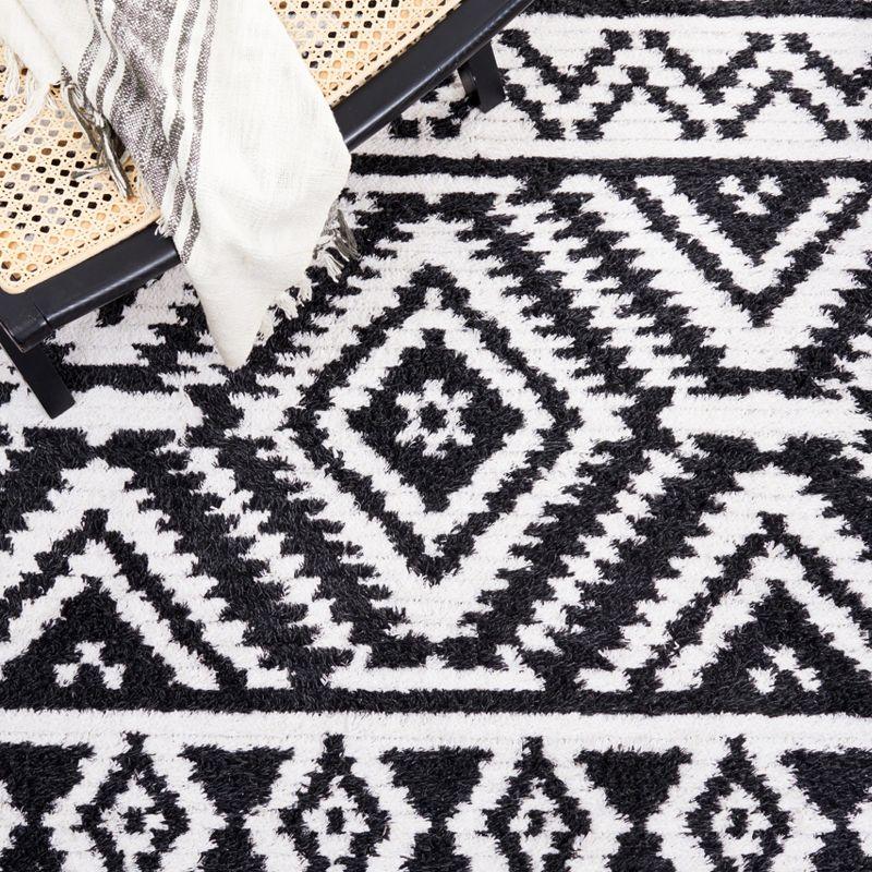 Nomadic Boho-Mod Black & Ivory Synthetic Area Rug - 6'4" x 9'6"