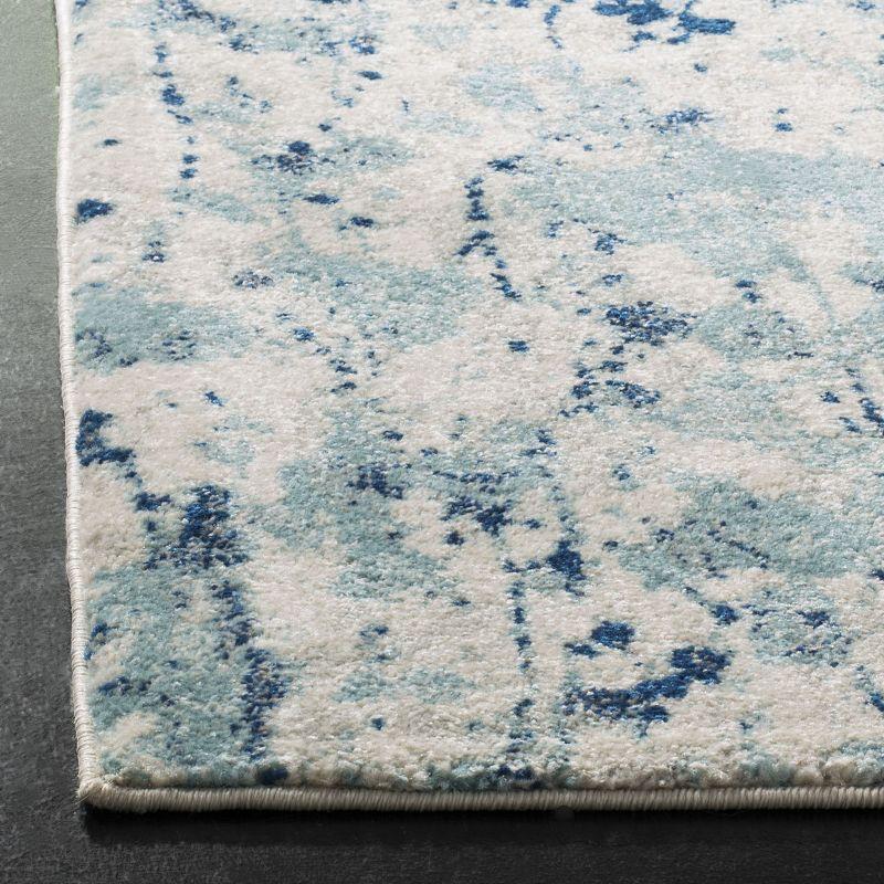 Ivory and Blue Speckled Print Synthetic Area Rug