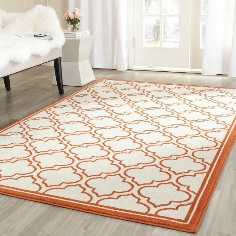 Ivory and Orange Geometric Low Pile Area Rug