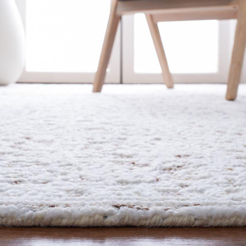 Ivory and Beige 3' x 5' Hand-Tufted Wool Area Rug