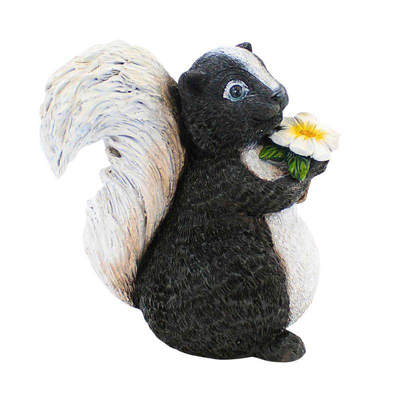 Whimsical Black and White Skunk Garden Statue with Flower