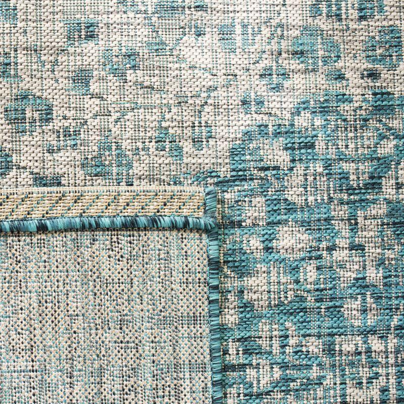 Teal and Cream Synthetic Indoor/Outdoor Area Rug