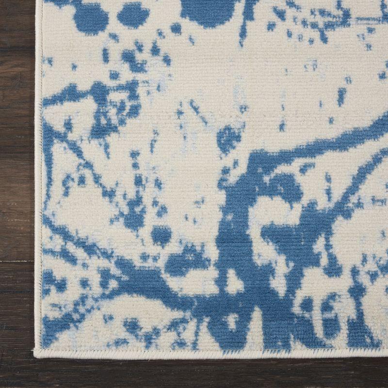 Ivory and Blue Abstract Synthetic 2' x 4' Easy-Care Area Rug