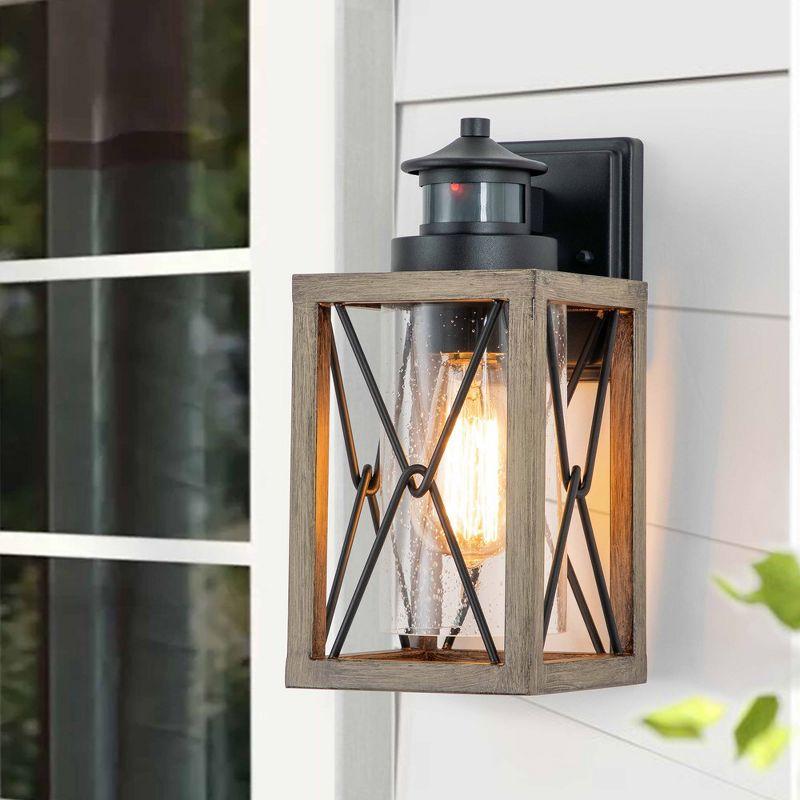 C Cattleya 1-Light Black and Faux Wood Motion Sensing Dusk to Dawn Outdoor Wall Light with Clear Seeded Glass