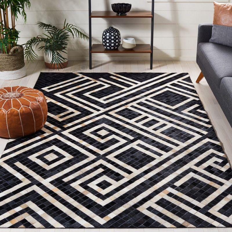 Handmade Black and Ivory Geometric Cowhide Area Rug