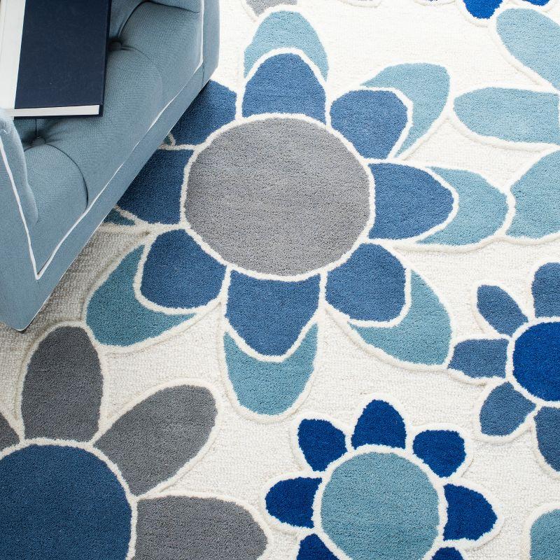 Safavieh Kids SFK923 Hand Tufted Area Rug - Ivory/Blue - 5'x8' - Safavieh.