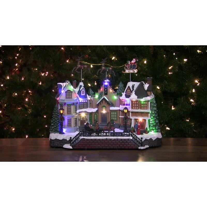 Northlight Seasonal 16" White and Brown LED Lighted and Animated Christmas Village with Flying Sleigh Tabletop Decor