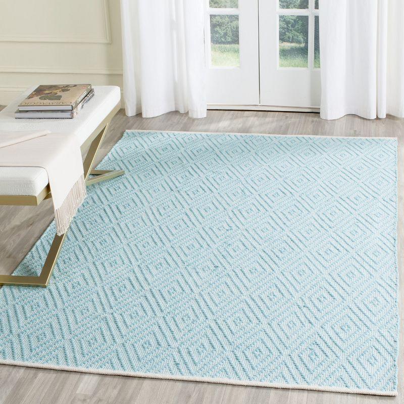 Turquoise and Ivory Geometric Cotton 4' x 6' Area Rug