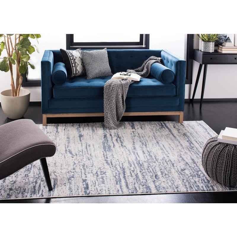 Ivory and Blue Abstract Synthetic 4' x 6' Easy-Care Area Rug