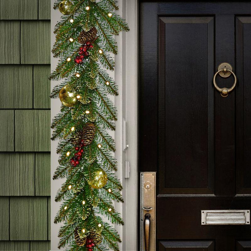 The Holiday Aisle® 9 ft. Glittery Gold Dunhill Fir Garland with Battery Operated LED Lights