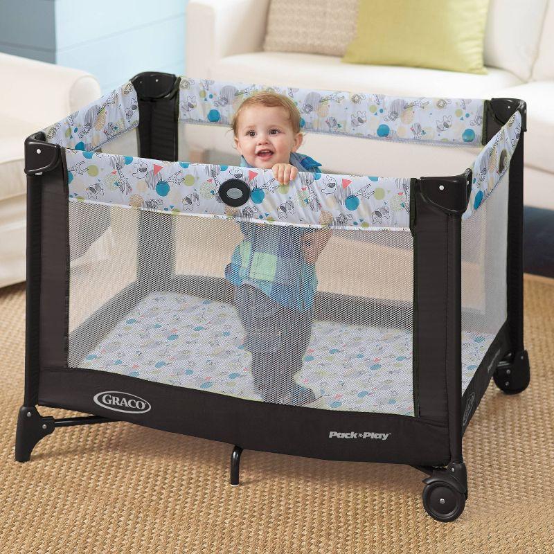 Compact Black and White Portable Playard with Mesh Sides