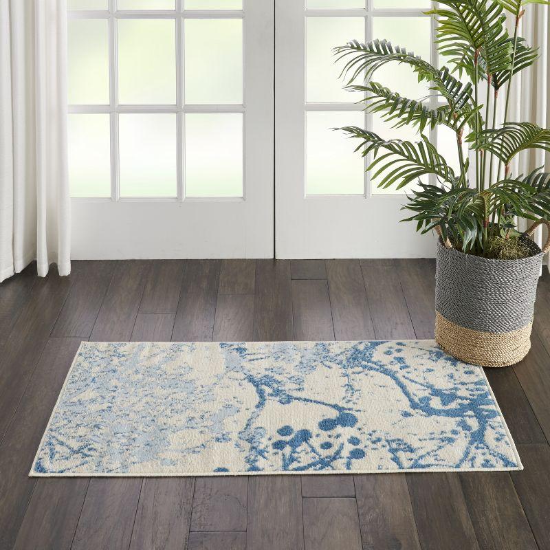 Ivory and Blue Abstract Synthetic 2' x 4' Easy-Care Area Rug