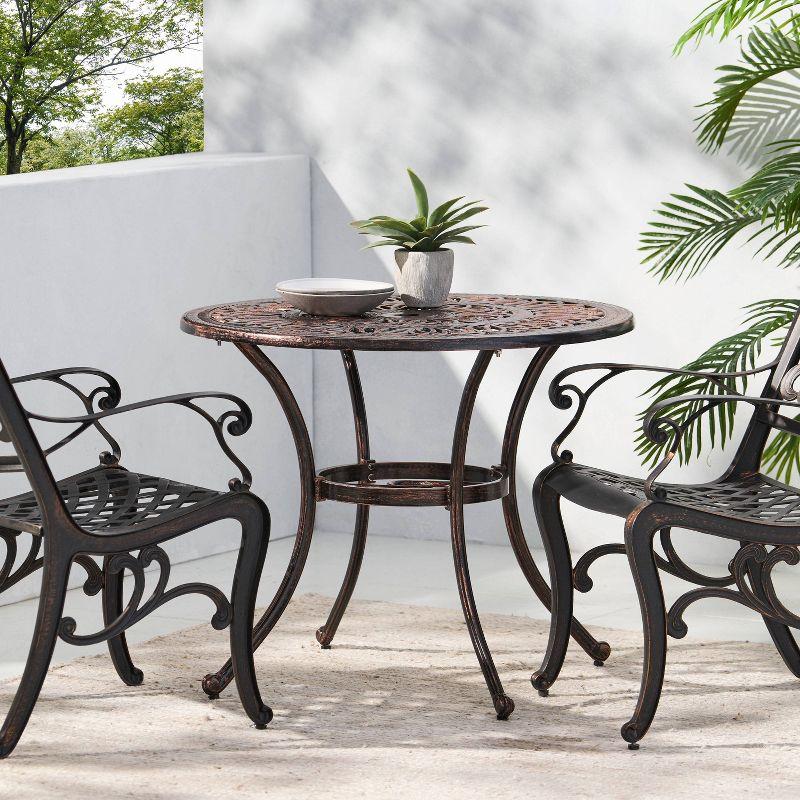 Fleur De Lis Living Outdoor Round Cast Aluminum Dining Table, Shiny Copper | Wayfair