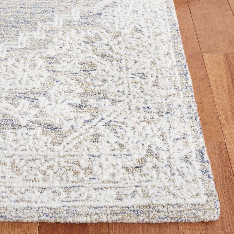 Ivory Tufted Handmade Wool and Synthetic 6' x 9' Area Rug