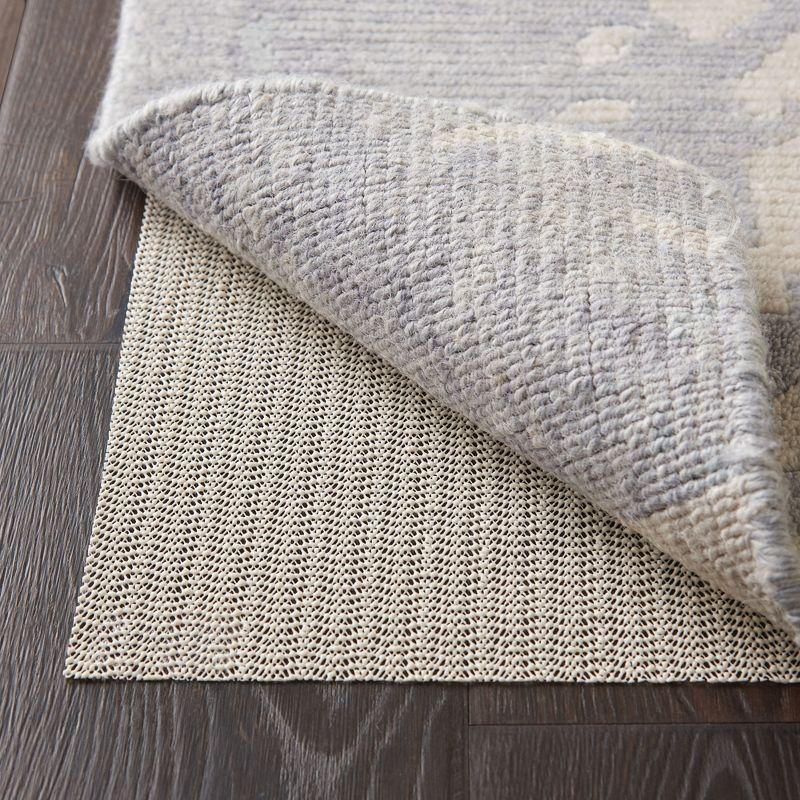 Ebern Designs Rectangle Shiftloc Solid Color Machine Made Polyester/Plastic/Acrylic Area Rug in Ivory