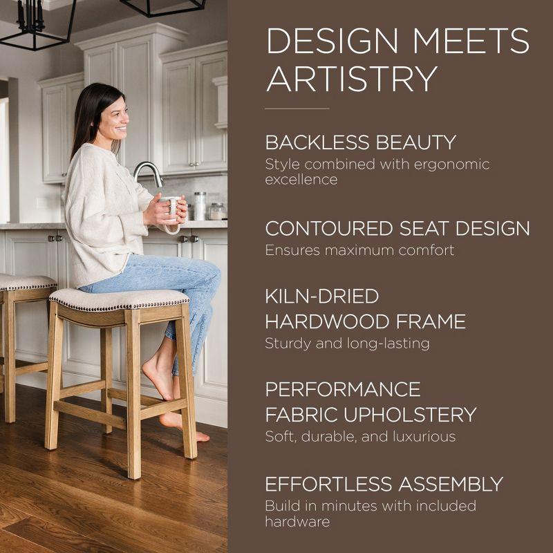 Maven Lane Adrien 26 Inch Counter Height Upholstered Backless Saddle Barstool in Natural Wood Finish with Wheat Cream Fabric Cushion Seat, Set of 3
