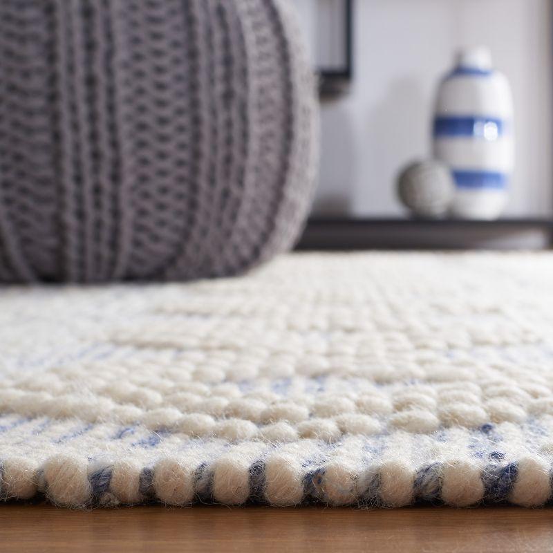 Ivory and Blue Handwoven Wool Area Rug with Fringe