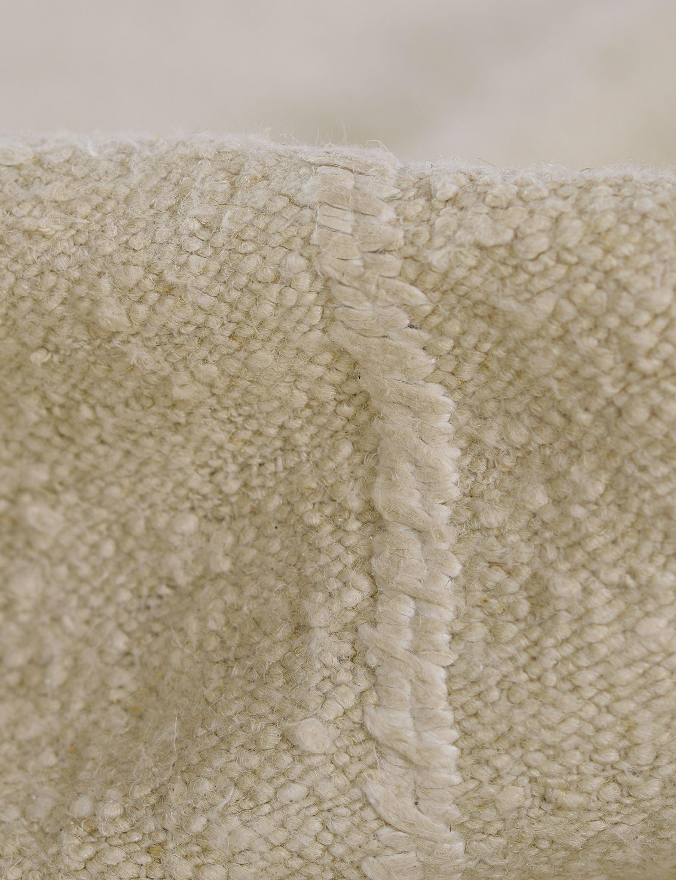 Koukila Ivory Solid Handwoven Wool 6' x 9' Area Rug
