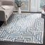 Ivory and Light Blue Geometric Synthetic 4' x 6' Area Rug